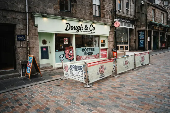 Local business storefront icon with shop awning and sign